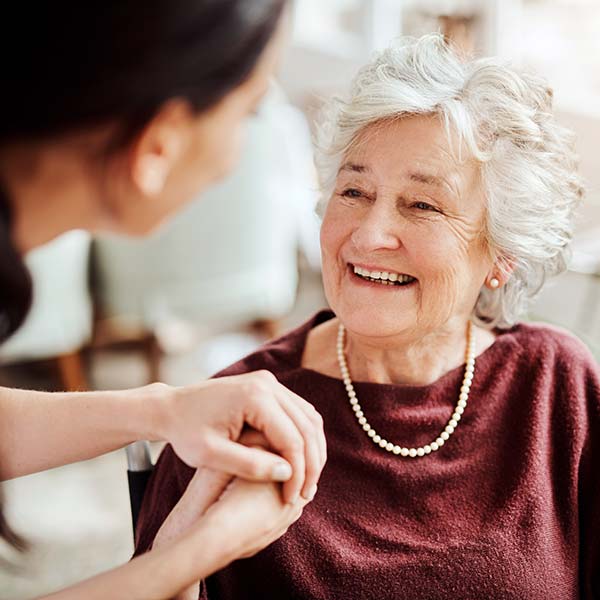 Young girl holding hand of a elder woman