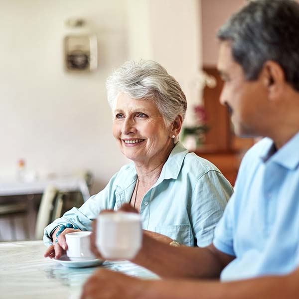 Elder couple having tea at the dining table